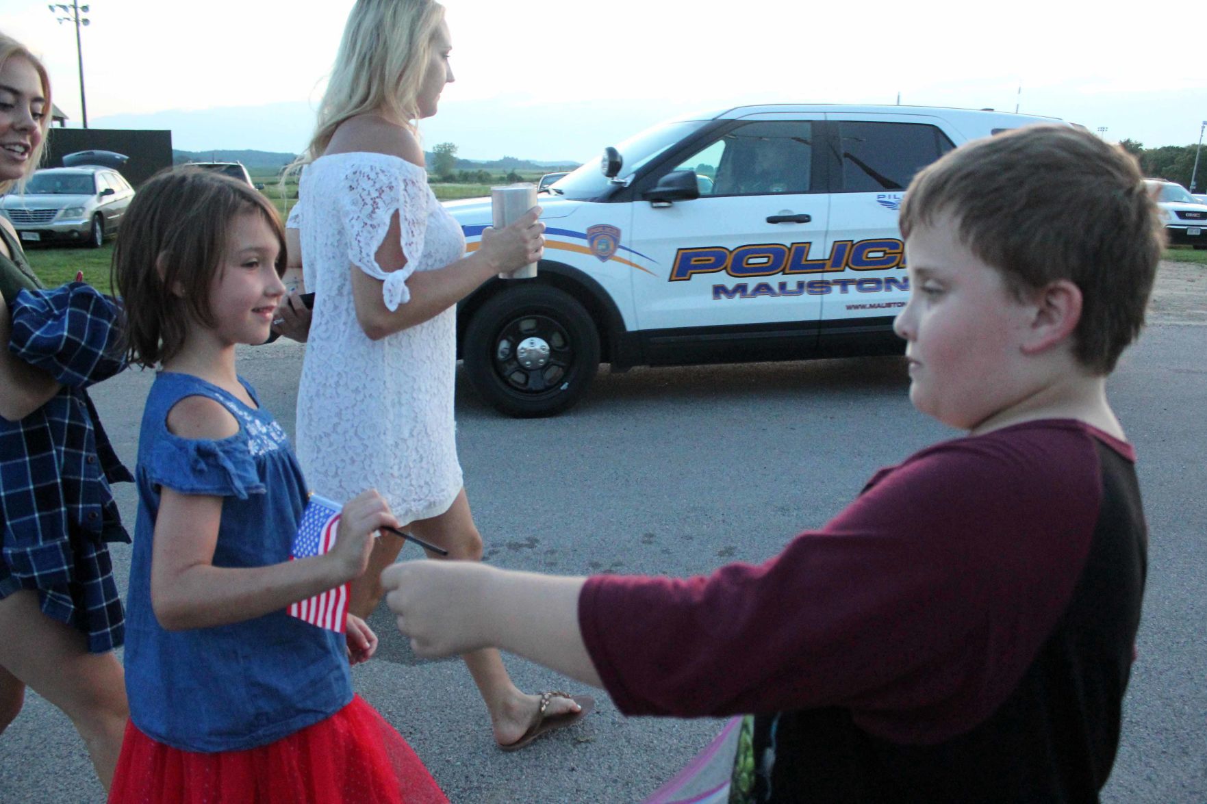 Oliver hands flag to Elise